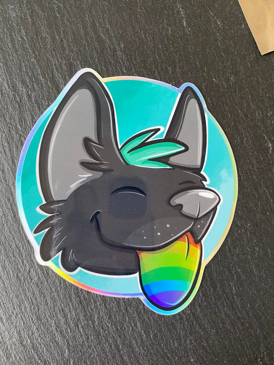 A round holographic sticker featuring a stylized fox character with a rainbow-colored tongue and a smiling expression.